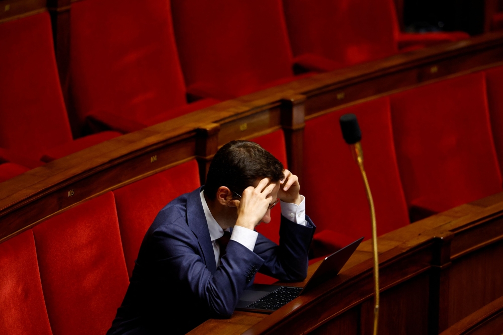 Member of parliament Vincent Trebuchet, of the Union des Droites (UDR) parliamentary group, looks at his laptop as he attends the questions to the government session at the National Assembly in Paris, France, October 22, 2024. — Reuters pic