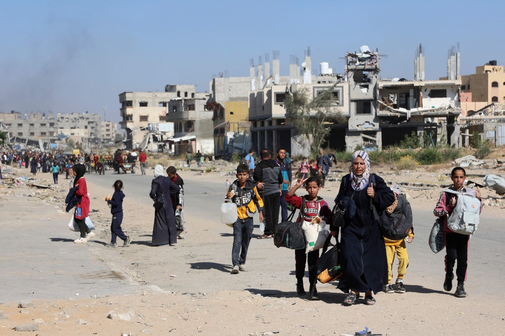 Displaced Palestinians fleeing Israeli military operations in Beit Lahia in the northern Gaza strip walk along the Salah al-Din main road in eastern Gaza City making their way to the city centre, on October 22, 2024, amid the ongoing war in the Palestinian territory between Israel and Hamas. — AFP pic