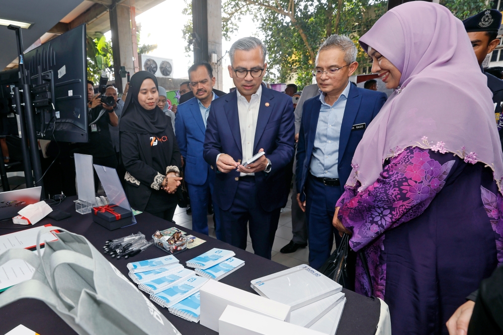 Communications Minister Fahmi Fadzil (third right) visits Bernama exhibition booth during the First Series of the Ministerial Lecture Programme at Universiti Teknologi Mara (UiTM). — Bernama pic