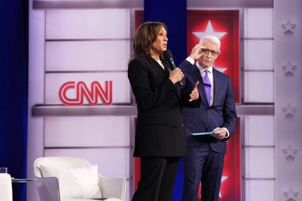 Democratic presidential candidate, U.S. Vice President Kamala Harris (left) speaks as CNN moderator Anderson Cooper looks on during a Presidential Town Hall event at Sun Center Studios on October 23, 2024 in Aston, Pennsylvania. — AFP pic