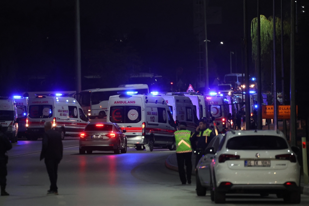 Ambulances wait along a road in Kahramankazan, a small town some 40km north of Ankara on October 23, 2024, in the vicinity of the gate of the Turkish Aerospace Industries after a huge explosion outside the headquarters left a number of people “dead and injured”. — AFP pic