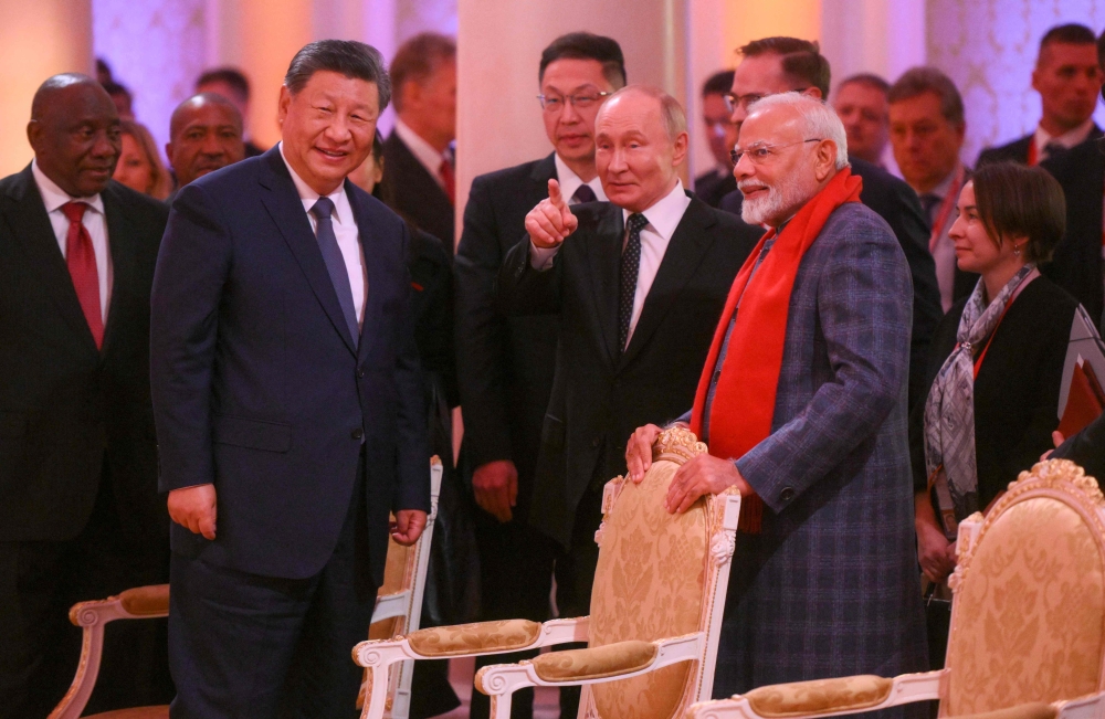 (From left) Chinese President Xi Jinping, Russia’s President Vladimir Putin and Indian Prime Minister Narendra Modi share a moment during an informal dinner on the sidelines of the Brics summit in Kazan, Russia. — AFP pic
