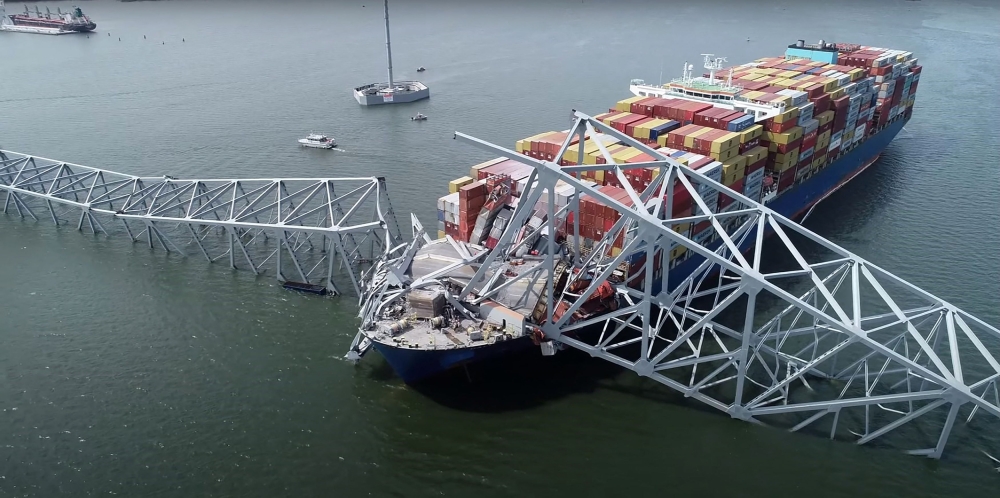This handout screegrab courtesy of the National Transportation Safety Board taken on March 26, 2028, shows part of the steel frame of the Francis Scott Key Bridge sitting on top of the container ship Dali after the bridge collapsed in Baltimore, Maryland, on March 26, 2024. — AFP pic