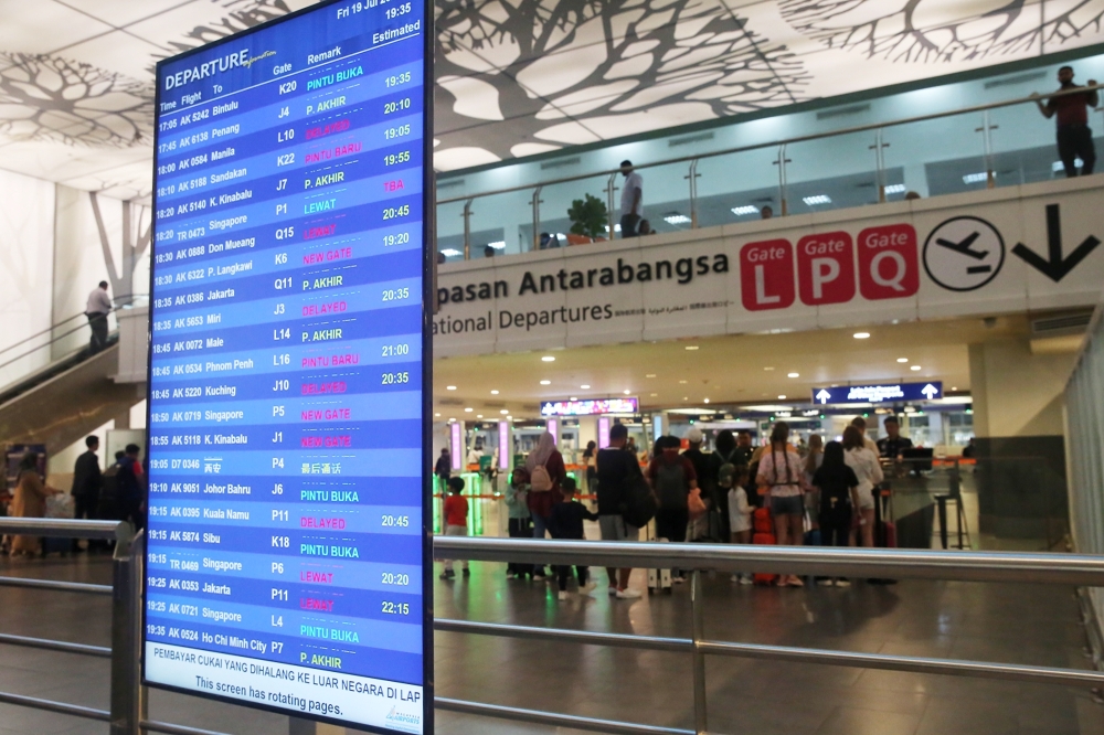 File photo of a flight departure board at KLIA2 showing delays as a result of a global IT system outage on July 19, 2024. — Picture by Choo Choo May