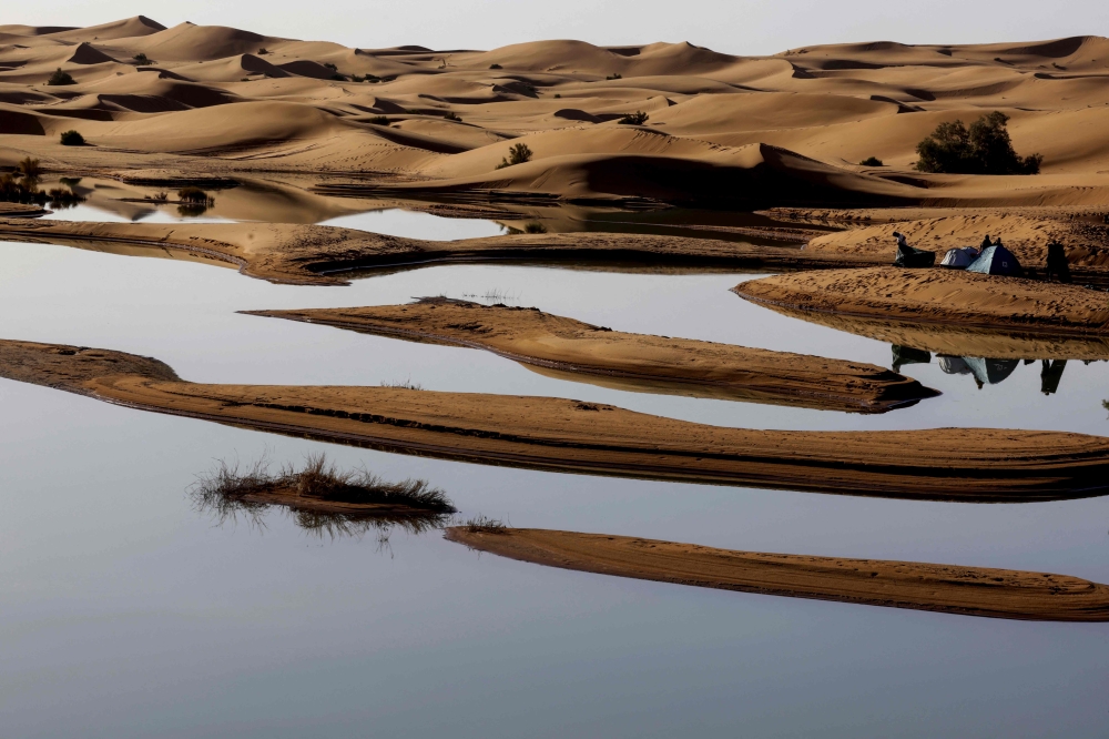 Tourists camp on the shores of Erg Znaigui, a seasonal lake in the village of Merzouga in the Sahara desert in southeastern Morocco on October 20, 2024. Last month's unusual torrential rains triggered floods that killed at least 18 people in areas of southern Morocco that straddle the Sahara Desert. — AFP pic