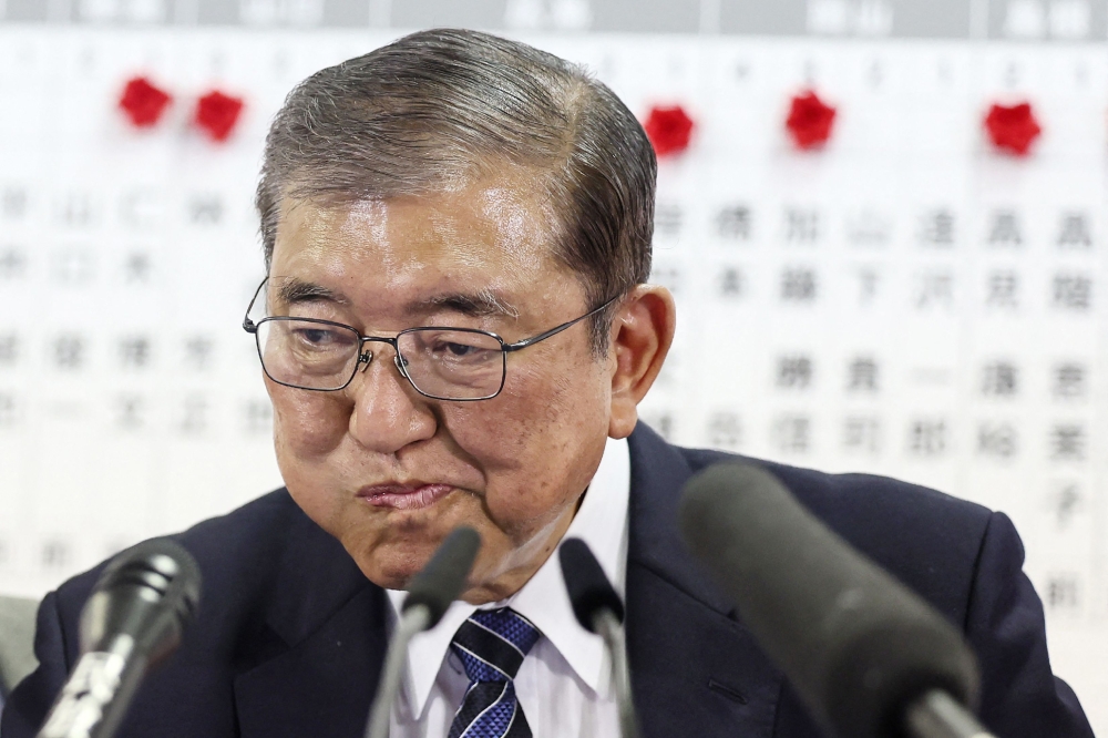 Japanese Prime Minister Shigeru Ishiba was on thin ice today after his ruling coalition was projected to have lost its parliamentary majority in disastrous snap elections. — AFP pic