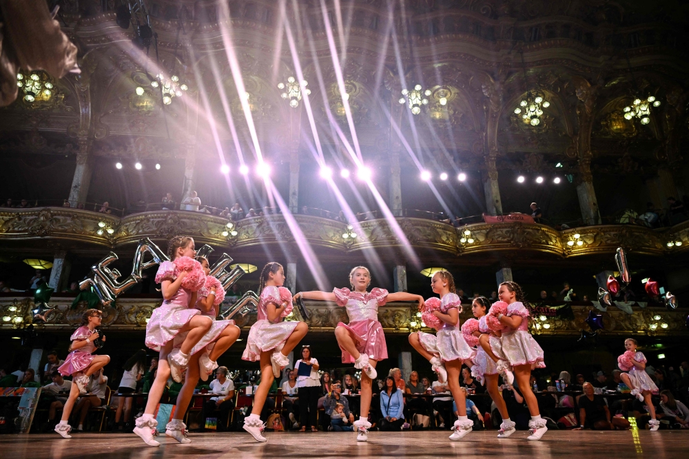 Members of the Platt Bridge Carnival Morris dancing group, competing in the Dinkies category, perform during in the Remix End of Season Championships at the Blackpool Tower Ballroom, in Blackpool September 15, 2024. — AFP pic