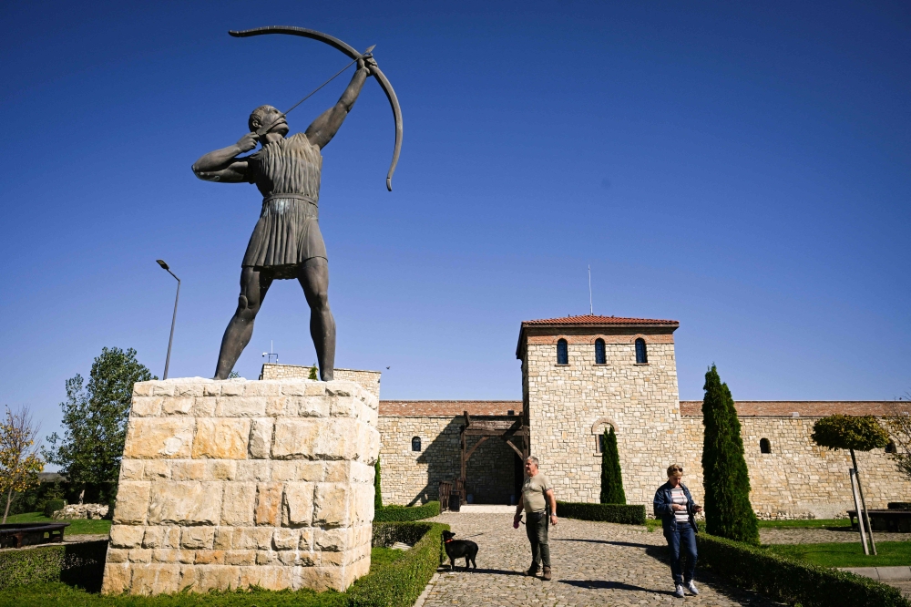 This photograph shows a monument and a replica of a castle in the Historical Park of the village of Neofit Rilski, north-east Bulgaria October 10, 2024. — AFP pic