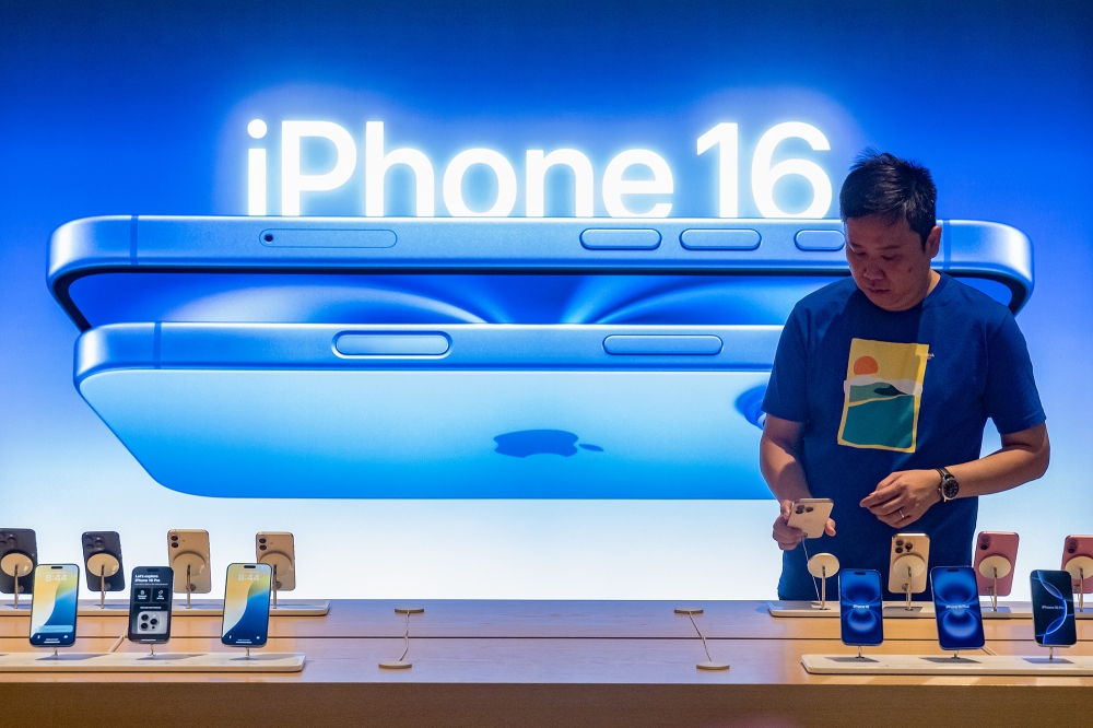 A customers tries out the newly launched iPhone 16 at an Apple store at the Tun Razak Exchange (TRX) in Kuala Lumpur September 20, 2024. — Picture by Firdaus Latif