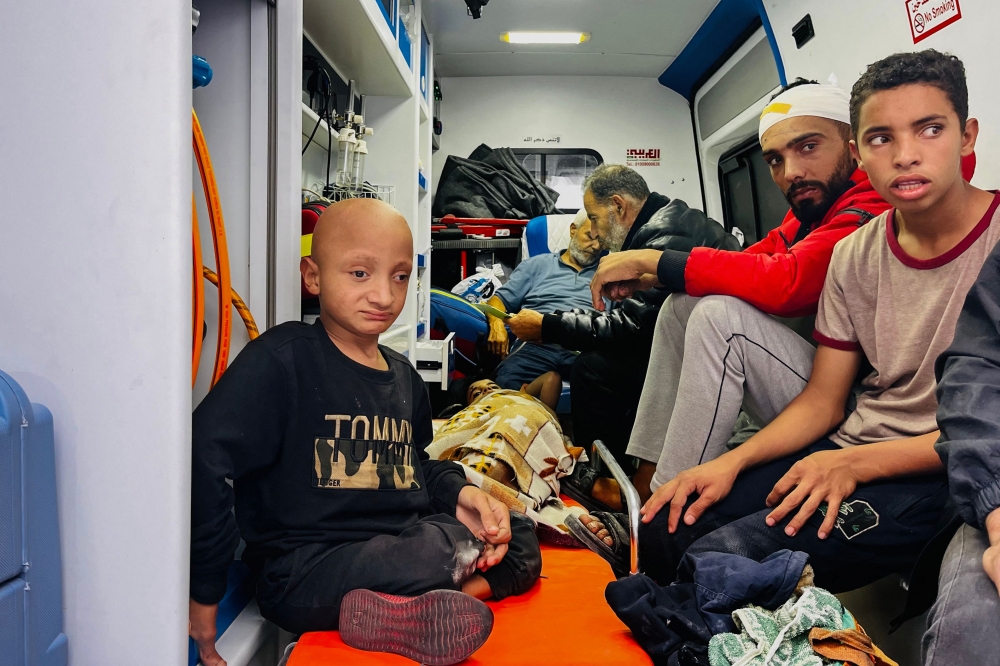 Medics evacuate injured people and cancer patients from the Kamal Adwan Hospital in Beit Lahia in the northern Gaza Strip on October 28, 2024, to al-Shifa hospital in Gaza City in a joint World Health Organisation and Palestinian Red Crescent initiative. — AFP pic