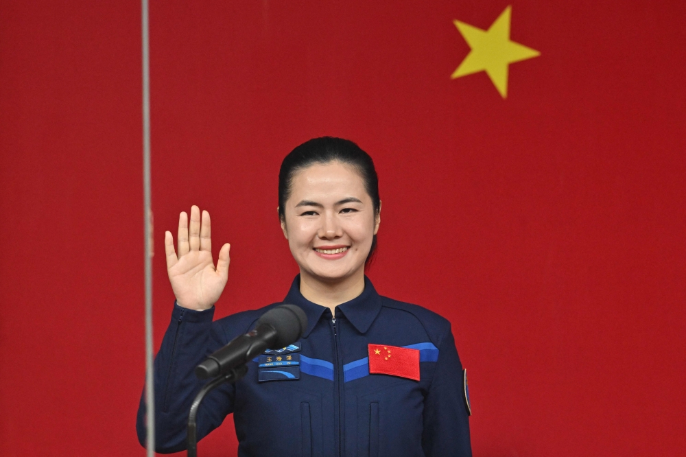 Astronaut Wang Haoze gestures during a press conference a day before the Shenzhou-19 mission at the Jiuquan Satellite Launch Centre in the Gobi desert in northwest China on October 29, 2024. — AFP pic