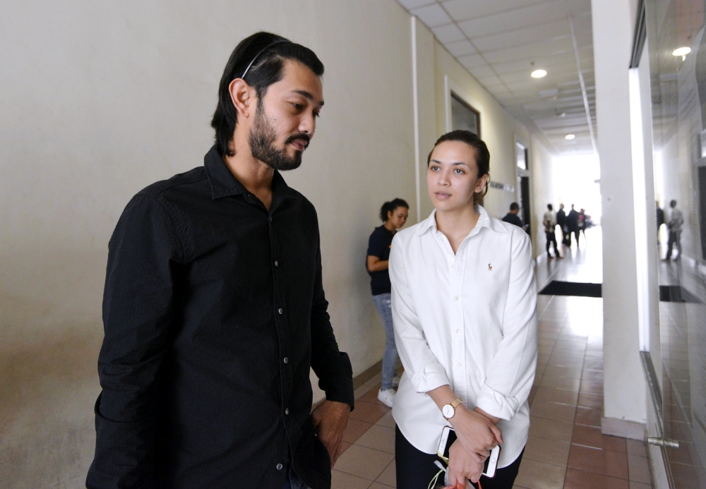 File photo: Farid Kamil and Diana Danielle outside the court room in 2018. — Picture by Ham Abu Bakar.