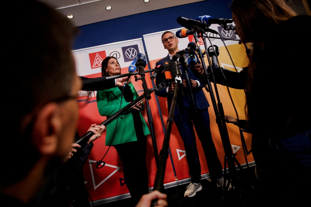 Daniela Cavallo, chairman of the general and group works council of Volkswagen AG, and Thorsten Groeger, district leader of Germany’s metal worker union IG Metall, speak to the media before a second round of wage talks with Volkswagen AG following VW’s announcement to lay off thousands of employees and close down at least three VW plants, in Wolfsburg, Germany October 30, 2024. — Reuters pic