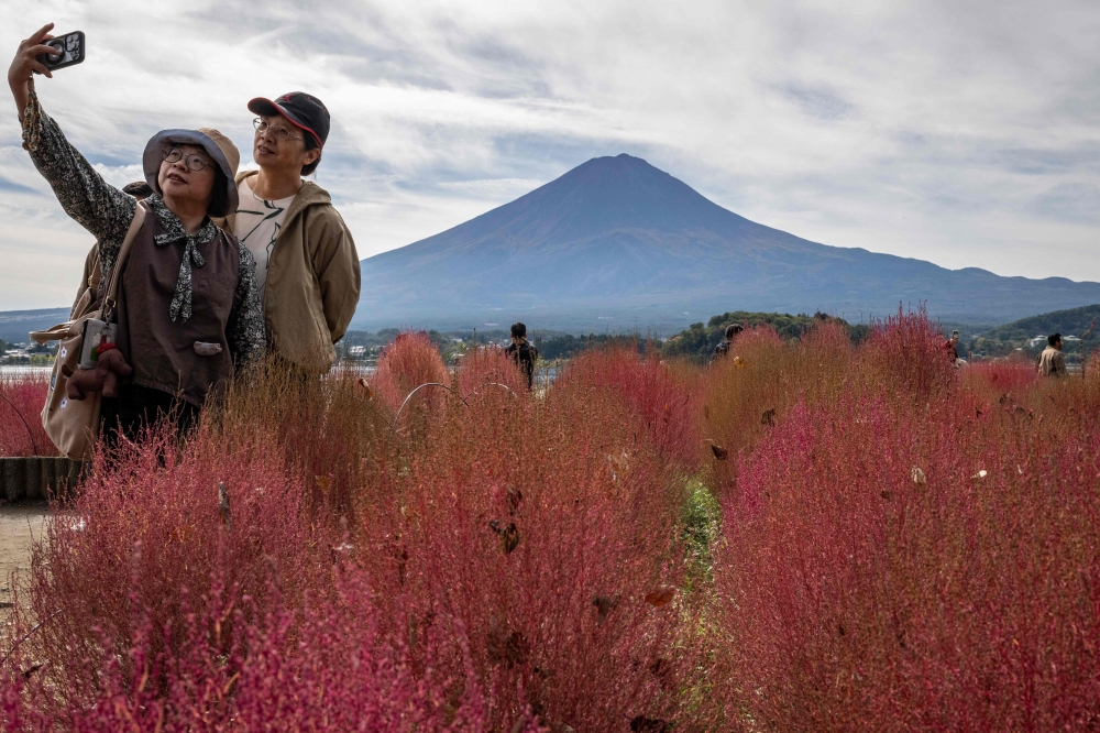 Japan’s Mount Fuji remained snow-less on October 31 — the latest date that its majestic slopes have been bare since records began 130 years ago. — AFP pic