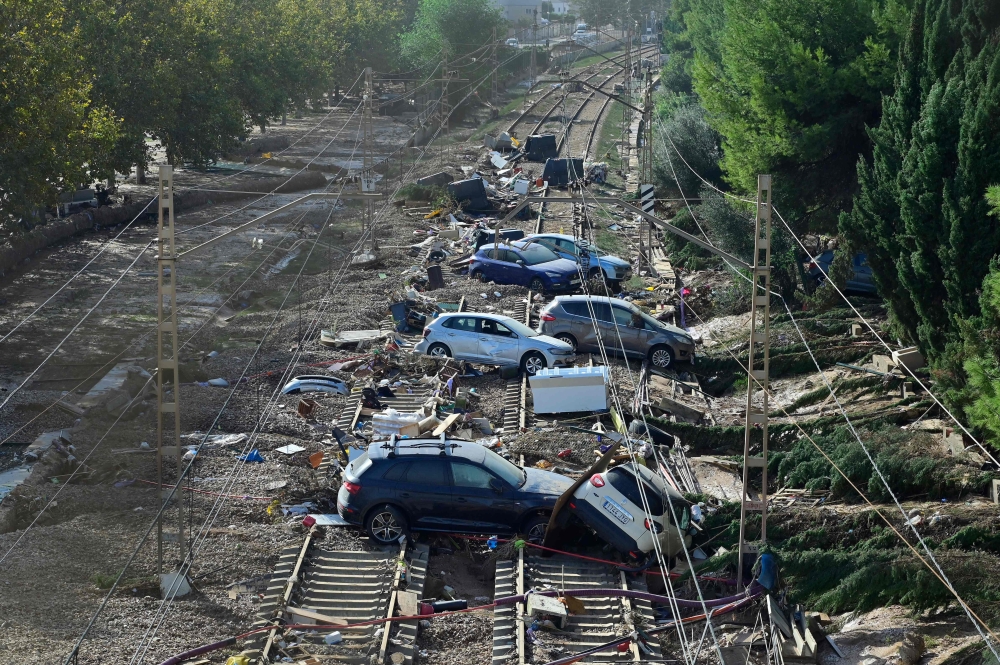 Wreckage of cars pile up on the on the railway on October 31, 2024 after flash floods ravaged the town of Alfafar, in the region of Valencia, eastern Spain. Rescuers raced on October 31, 2024 to find survivors and victims of once-in-a-generation floods in Spain that killed at least 95 people and left towns submerged in a muddy deluge with overturned cars scattered in the streets. — AFP pic 