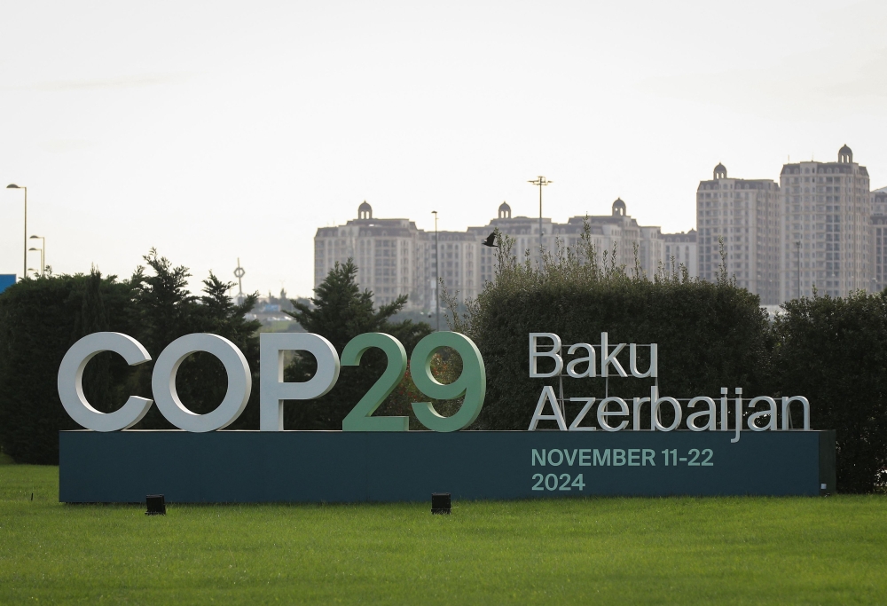 A view shows a sign of the COP29 United Nations Climate Change Conference with a backdrop of the cityscape in Baku, Azerbaijan October 31, 2024. — Reuters pic  