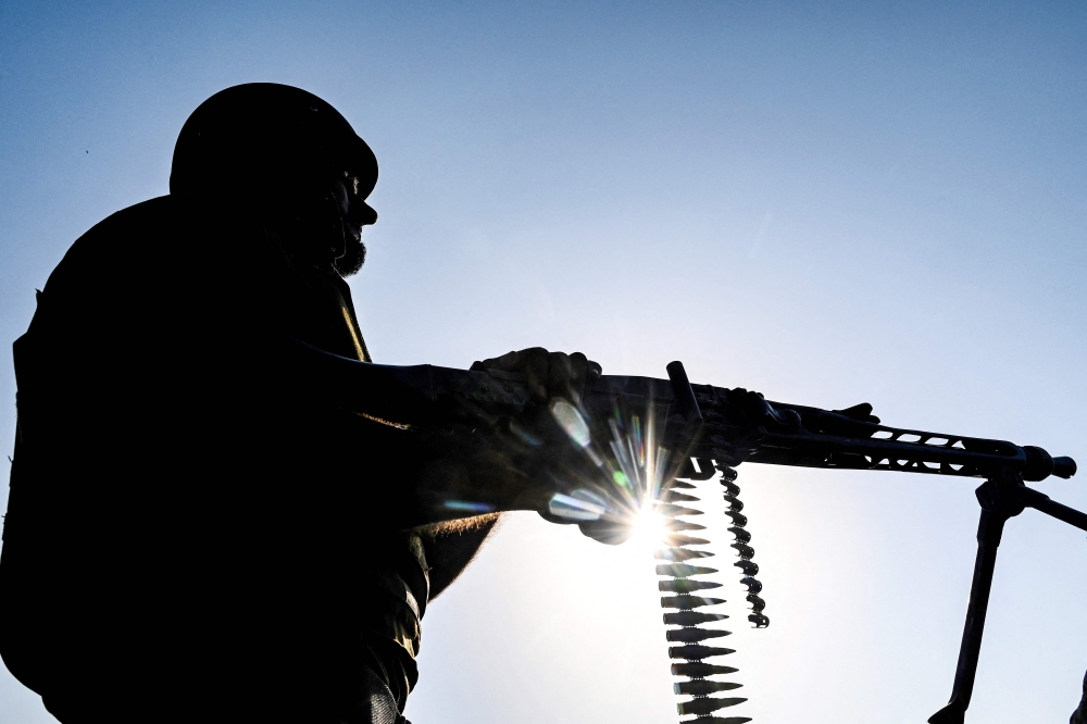 This photograph taken on October 9, 2024 shows an elite police personnel monitoring security at a post on a sandy island along the Indus river, in the 'Katcha lands' at Rahim Yar Khan district. On TikTok, Facebook, YouTube and Instagram Pakistani gangster Shahid Lund Baloch fascinates tens-of-thousands with defiant messages delivered gun-in-hand, glamourising his exile lifestyle and cultivating a ‘Robin Hood’ reputation. — AFP pic