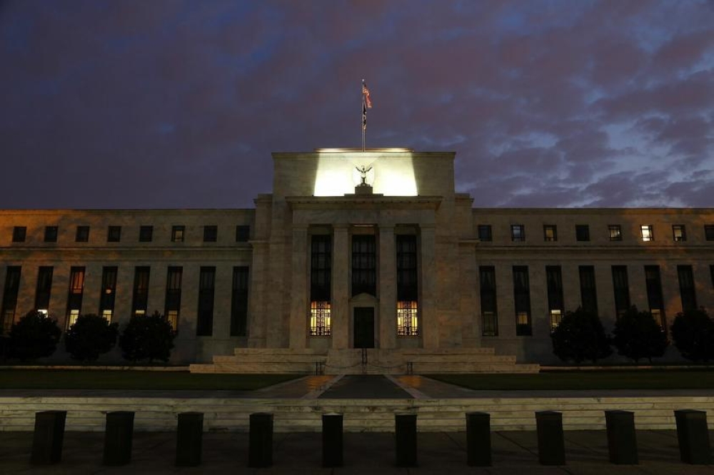 A general view of the US Federal Reserve building as the morning sky breaks over Washington, July 31, 2013. The Federal Reserve System includes a decentralised network of 12 regional reserve banks and a seven-member Board of Governors in Washington. — Reuters pic