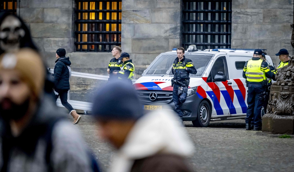 Netherlands' Police officers patrol on Dam Square in Amsterdam, on November 9, 2024. — AFP pic
