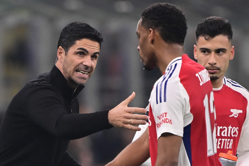 Arsenal's Spanish manager Mikel Arteta speaks to Arsenal's Dutch defender #12 Jurrien Timber during the UEFA Champions League football match between Inter Milan and Arsenal at the San Siro stadium in Milan on November 6, 2024. — AFP pic