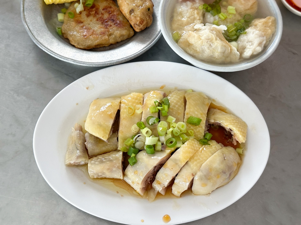 Poached chicken bathed in their sauce made with their own brewed soy sauce and oil are a crowd favourite. — Picture by Lee Khang Yi