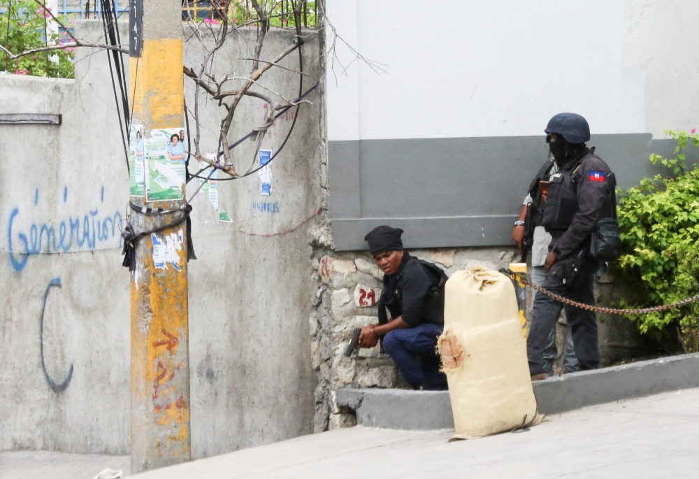 Haitian police stand behind a wall during clashes with gangs, in Port-au-Prince, Haiti November 11, 2024. — Reuters pic