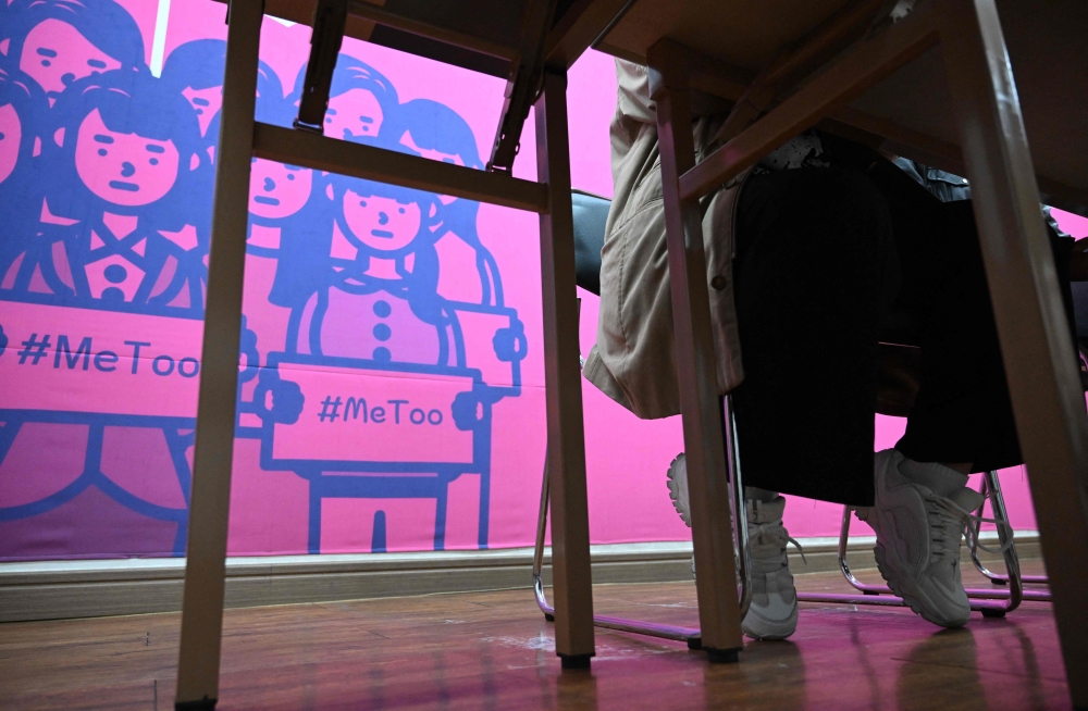 This picture taken on November 1, 2024 shows On Ji-goo, who wanted to use her pen name and declined to reveal her face for security reasons, attending an interview with AFP at a support centre for victims of sexual violence in Jinju. South Korean aspiring writer On Ji-goo did not consider herself a feminist but changed her mind after she was attacked by a man for having short hair. On was targeted while working her part time job in a convenience store because of her hair cut, which is loosely associated with South Korea's women's rights movement. — AFP pic