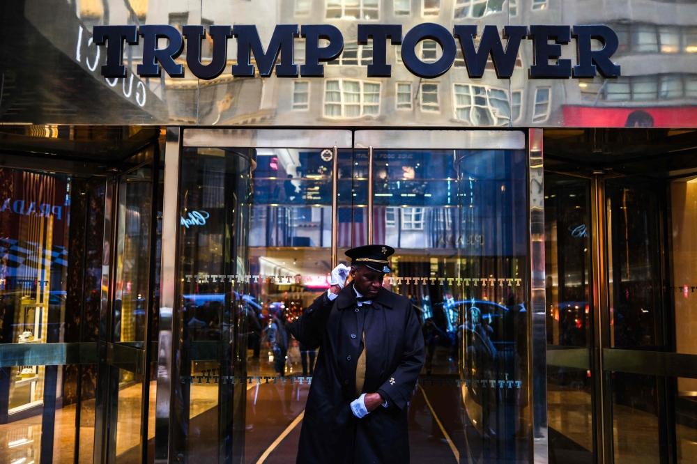 A doorman is seen in front of the entrance of the Trump Tower on Fifth Avenue in New York City on November 12, 2024. — AFP pic