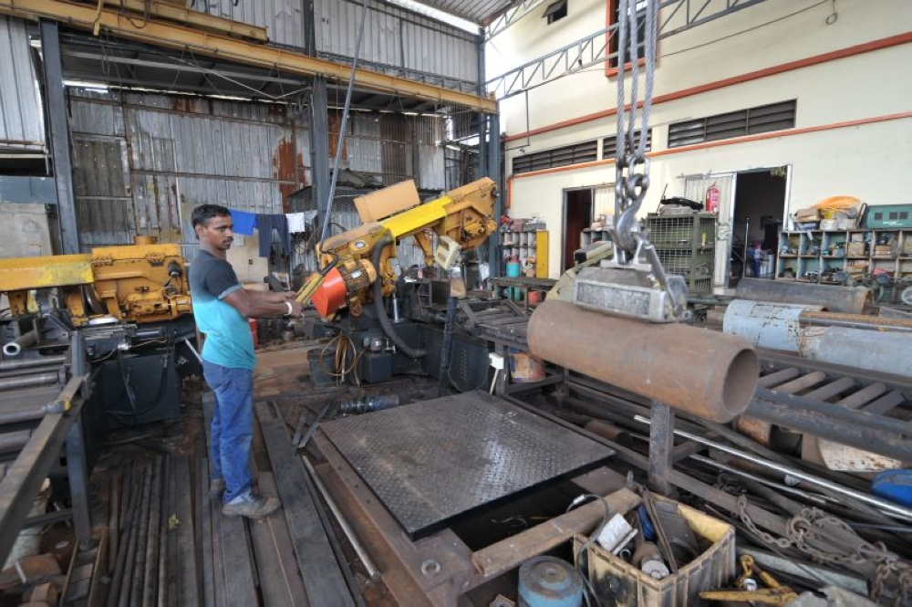 File picture of a worker in a scrap metal shop. — Picture by KE Ooi