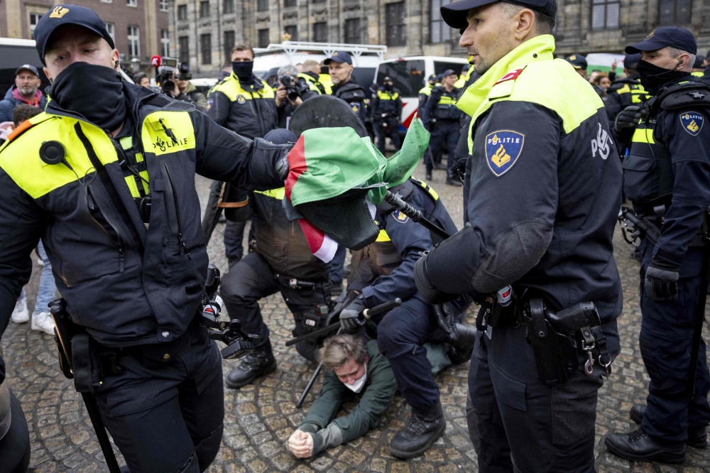 Police officers clash with protestors during a demonstration on Dam Square on November 10 following tensions and violence surrounding supporters of Israeli soccer club Maccabi Tel Aviv. — AFP pic