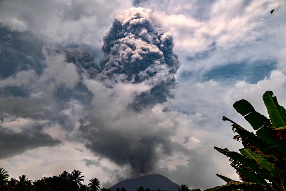 File picture of Mount Ibu in eastern Indonesia spewing a six-kilometre cloud of ash into the sky on May 21, 2024. Mount Ibu erupted on Thursday, sending a column of ash up to 3km high and prompting the second-highest aviation alert, according to the Volcanology and Geological Disaster Mitigation Centre. — AFP pic/Indonesian Geological Agency