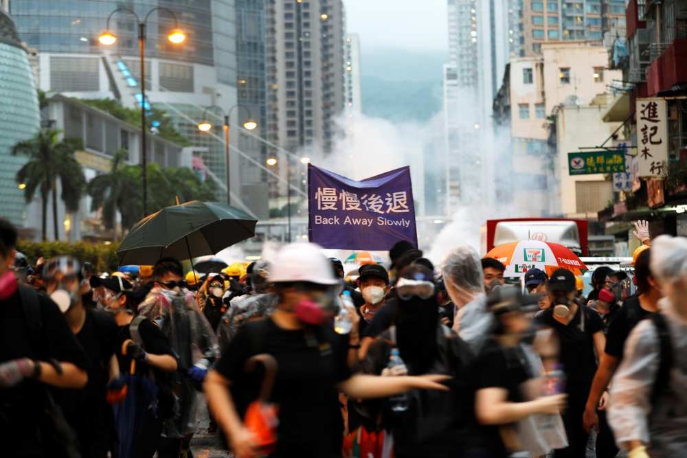 File picture of anti-extradition Bill protesters running as riot police fire tear gas during a protest in Hong Kong August 25, 2019. — Reuters pic