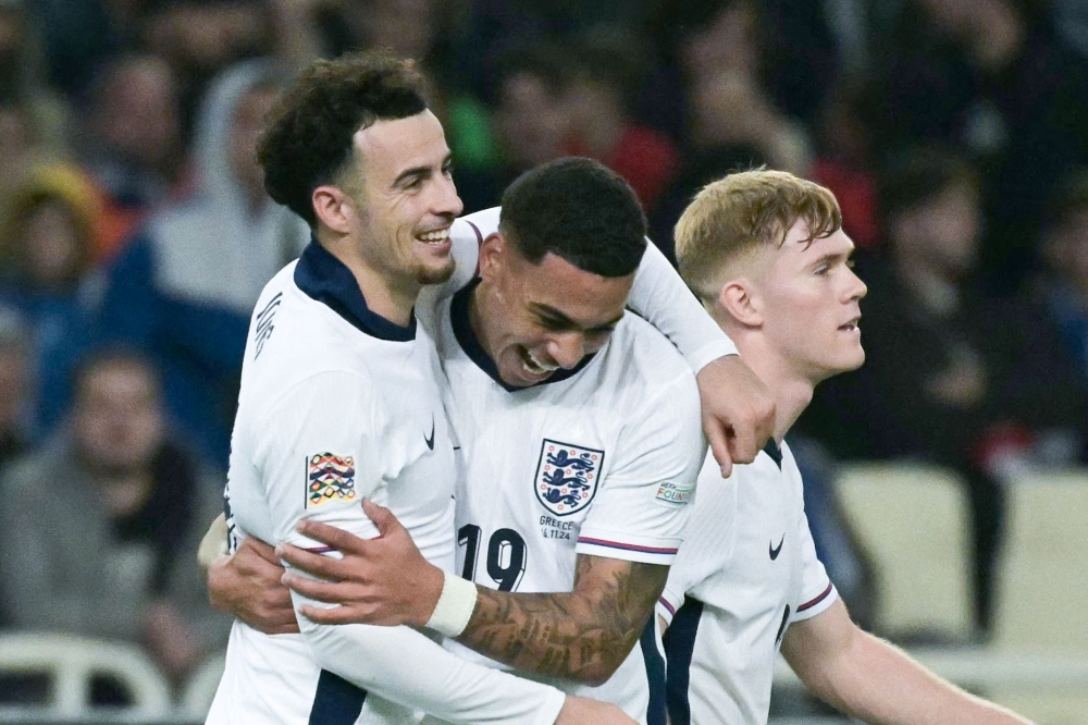 England's midfielder Curtis Jones (left) celebrates with forward Morgan Rogers after scoring his team's third goal during the UEFA Nations League, League B group B2 football match between Greece and England at Olympic Athletic Center of Athens 