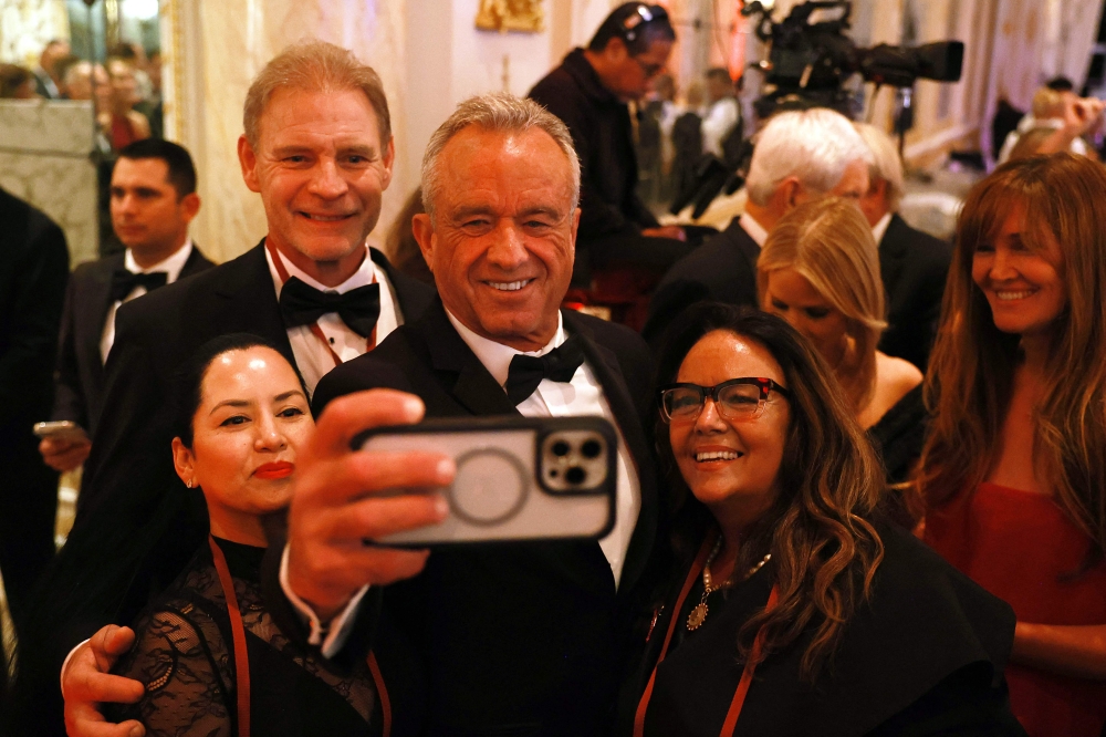 Robert F. Kennedy Jr. takes a selfie with guests at the America First Policy Institute Gala held at Mar-a-Lago on November 14. —AFP pic