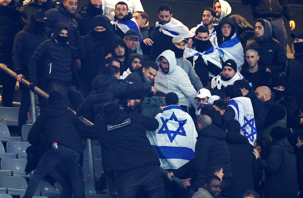 Israel fans clash with security staff during the match with France. — Reuters pic