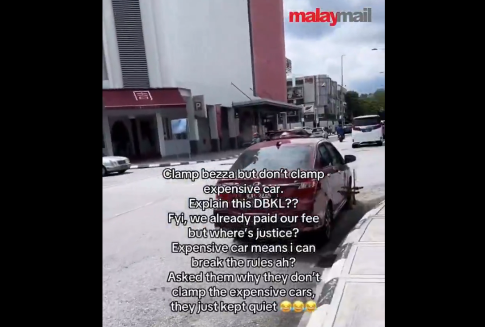 A screen capture from the video in which the owner of a Perodua Bezza accused Kuala Lumpur City Hall parking enforcers of selective action.