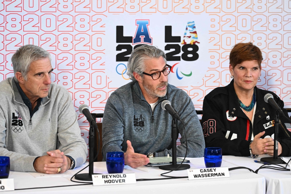 Casey Wasserman (C), Coordination Commission for the Olympic and Paralympic Games Los Angeles 2028 (LA28) chairperson and president, speaks alongside Reynold Hoover (L), LA28 Chief Executive Officer, and Nicole Hoevertsz (R), IOC Vice President and LA28 Coordination Commission Chair, during an LA28 and International Olympic Committee (IOC) press conference at the University of California Los Angeles campus (UCLA) in Los Angeles, on November 14. — AFP pic