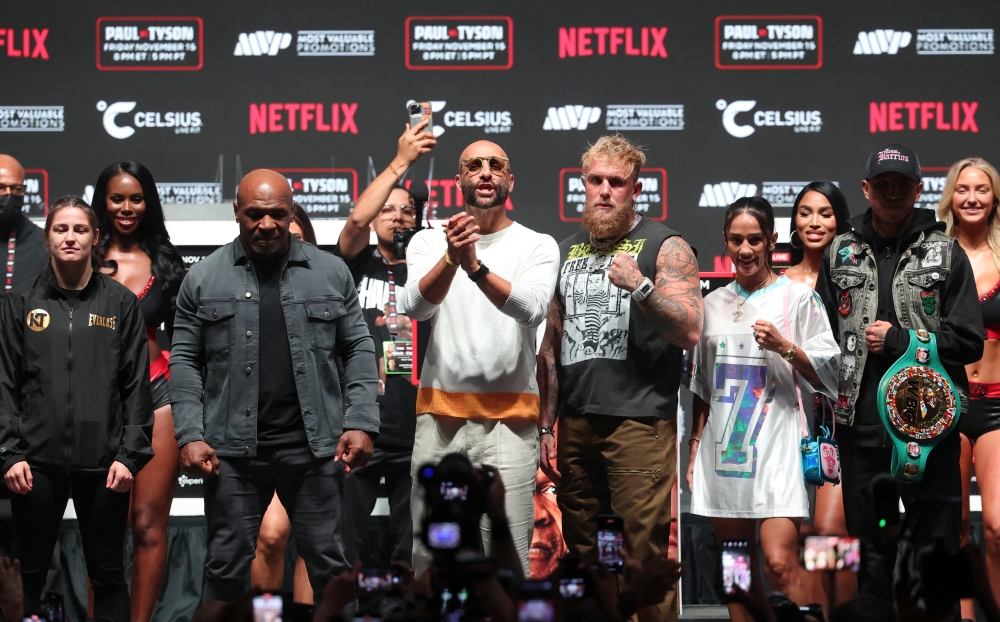 Jake Paul (right) faces off with Mike Tyson (left) during a press conference at The Pavilion at Toyota Music Factory. — Reuters pic