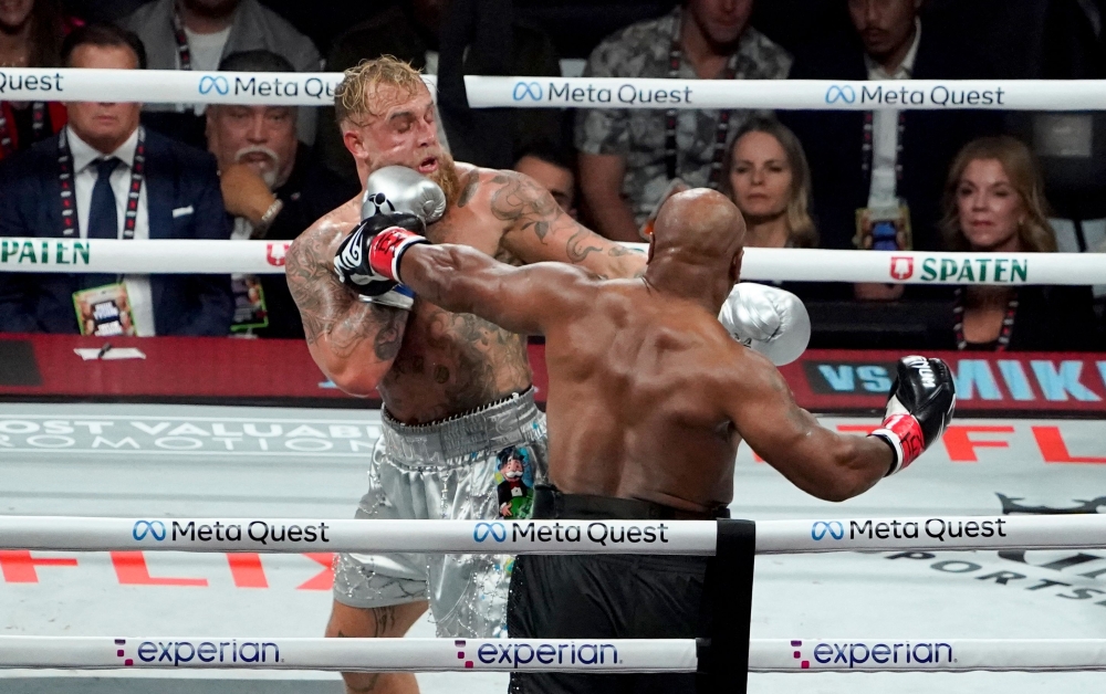 US retired pro-boxer Mike Tyson (right) and US YouTuber/boxer Jake Paul (left) fight during the heavyweight boxing bout at The Pavilion at AT&T Stadium in Arlington, Texas, November 15, 2024. — AFP pic