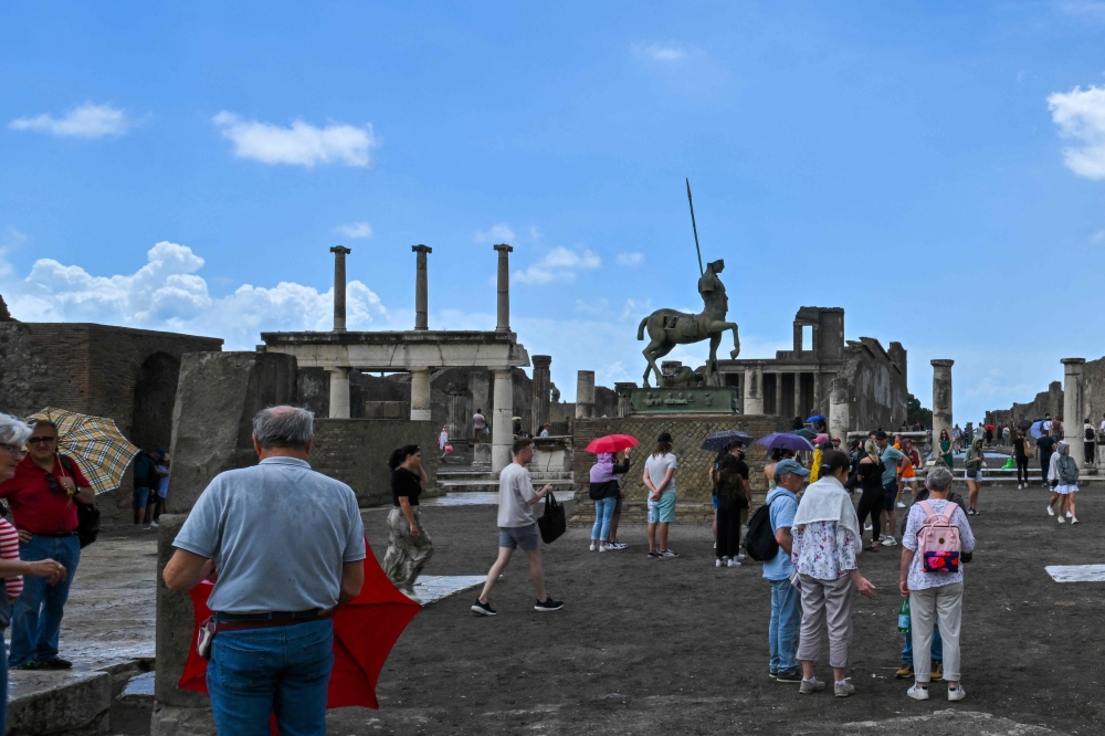 Visitors tour the Archaeological Park of Pompeii, near Naples, southern Italy June 9, 2022. Daily cap of 20,000 visitors to archaeological park comes into effect on November 15, 2024. — AFP pic