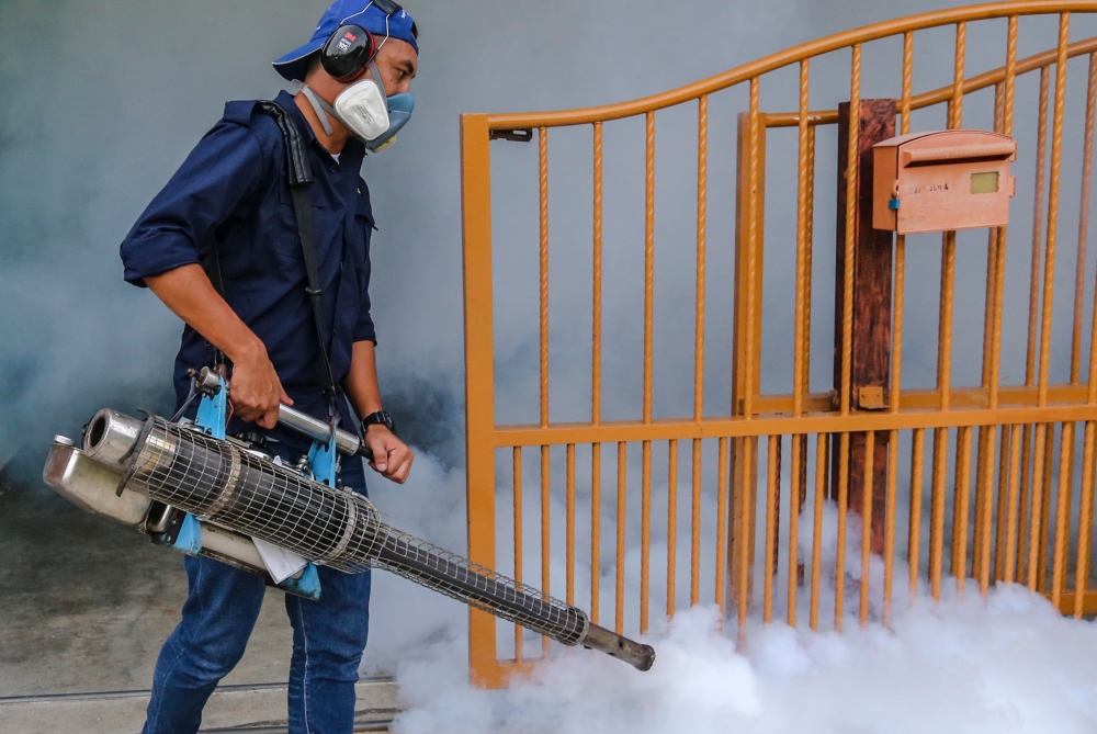 A health worker sprays insecticide to prevent the spread of dengue fever in Kulim, Kedah. — Picture by Firdaus Latif