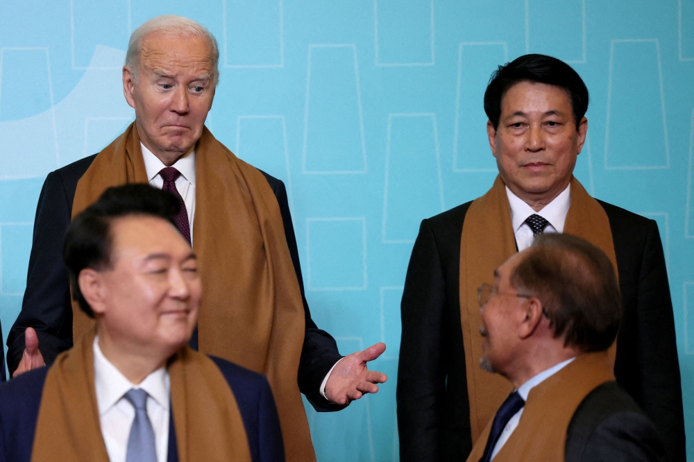 U.S. President Joe Biden reacts as he arrives to pose for a family photo with Vietnam's President Luong Cuong, South Korea's President Yoon Suk Yeol and Malaysia's Prime Minister Anwar Ibrahim during the APEC summit in Lima, Peru, November 16, 2024. — Reuters pic