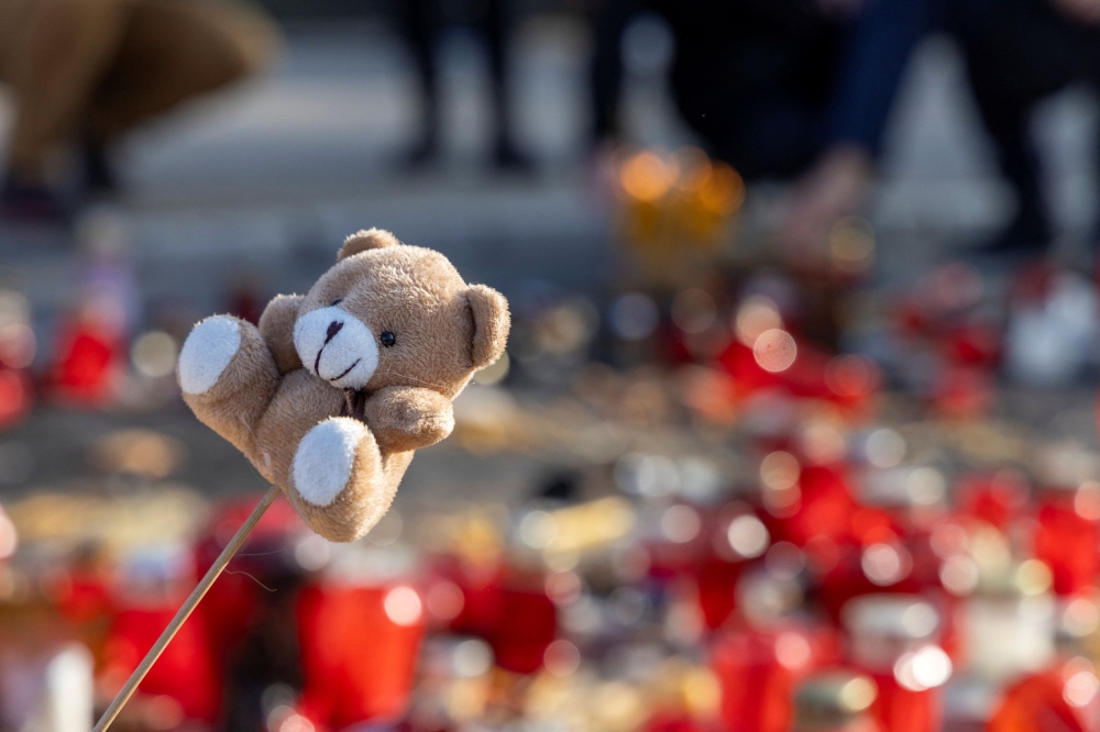 A stuffed toy is seen as people light candles during a protest over a fatal collapse of a roof at a railway station, for which they blame negligence and corruption by authorities, in Novi Sad, Serbia, November 17, 2024. — AFP pic