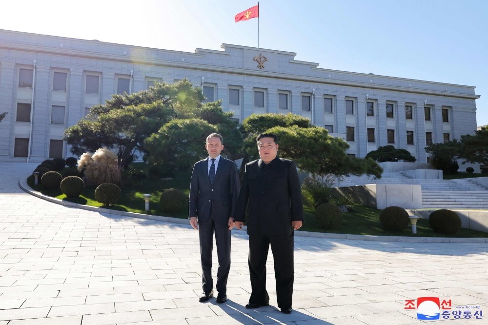 This picture taken on November 18, 2024 and released from North Korea’s official Korean Central News Agency (KCNA) via KNS on November 19, 2024 shows North Korea’s leader Kim Jong-un (right) posing with Russia’s Minister of Natural Resources and Ecology Alexander Kozlov at the headquarters of the Central Committee of the Communist Party in Pyongyang. — KCNA pic via KNS/AFP