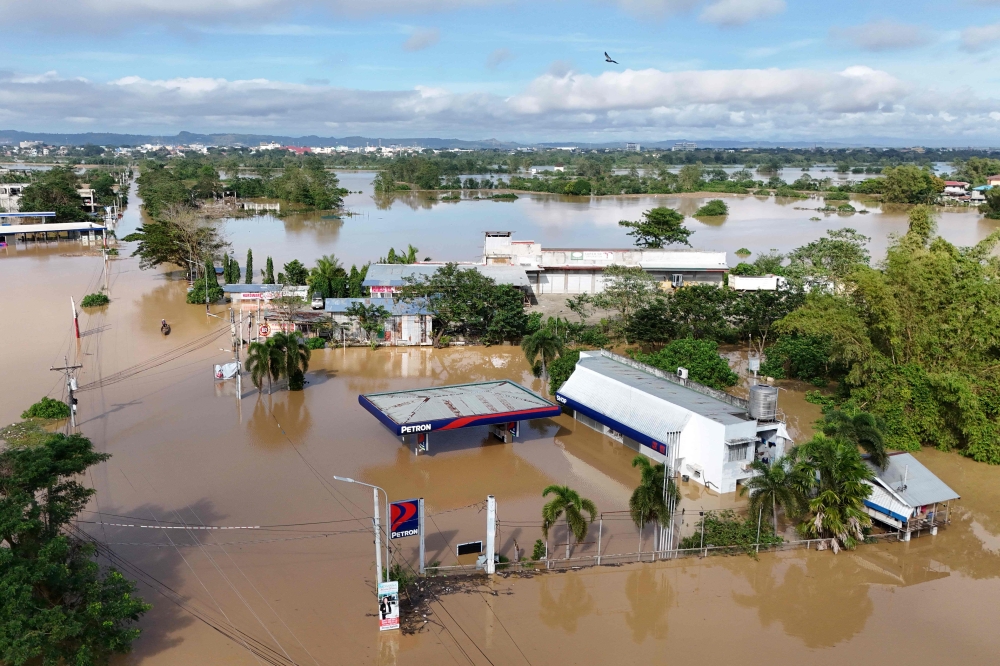 This aerial photo shows buildings submerged in floodwaters due to a swollen river caused by heavy rains from Super Typhoon Man-yi in Tuguegarao City, Cagayan province. — AFP