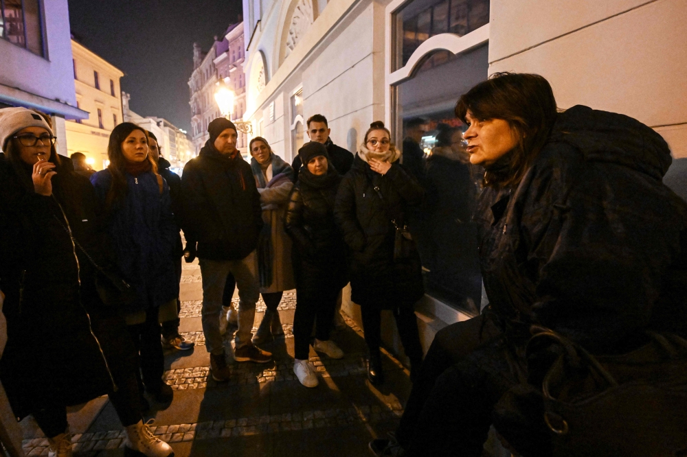 Lada (right), a 54-year-old prostitute and one of six tourist guides working for the Pragulic association, shows tourists round the Czech capital’s underworld which used to be her domain for decades on November 8, 2024 in Prague, Czech Republic. –– AFP pic 