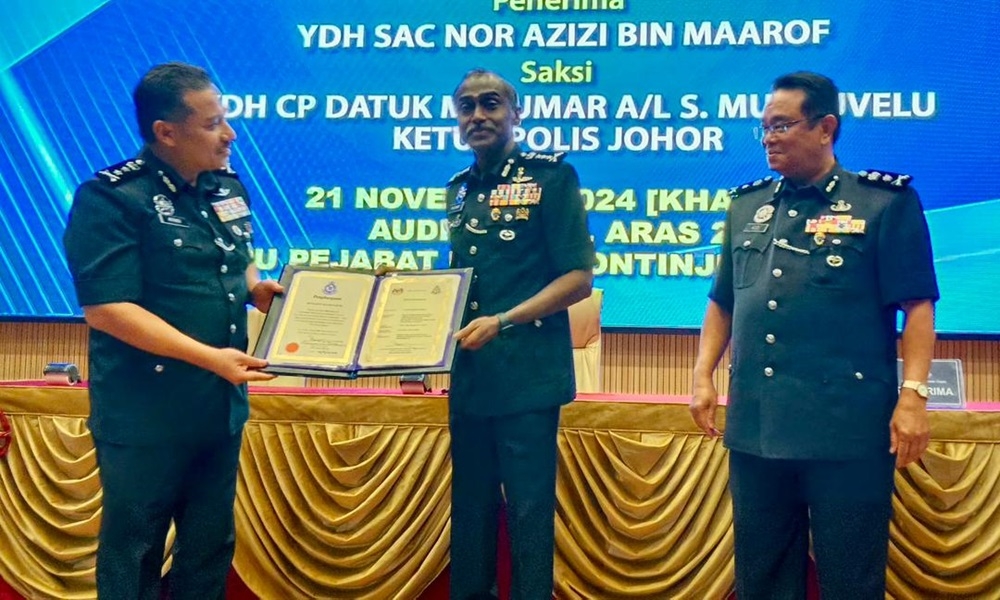 Johor police chief Datuk M. Kumar (centre) with the outgoing deputy state police chief Afandi Senin (left) who will be replaced by lNor Azizi Maarof (right) at the Johor police contingent headquarters in Johor Baru November 21, 2024. — Picture by Ben Tan
