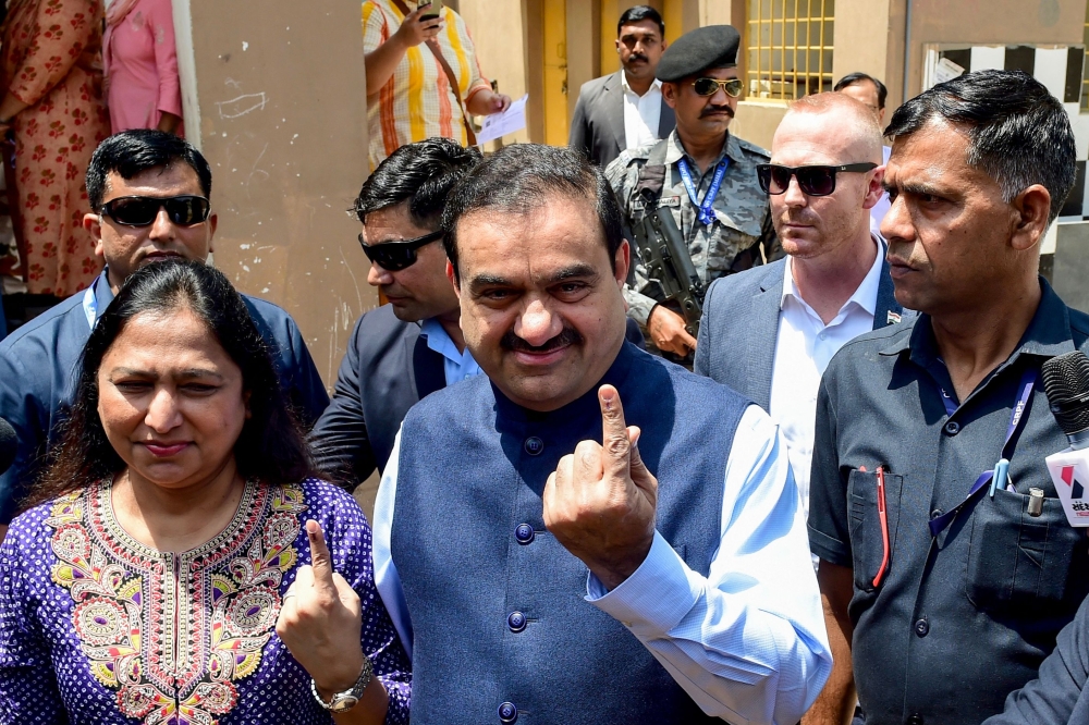 Gautam Adani Chairperson of Indian conglomerate Adani Group and his wife Priti Adani show their inked finger after casting their ballot to vote in Ahmedabad on May 7, 2024. — AFP file pic
