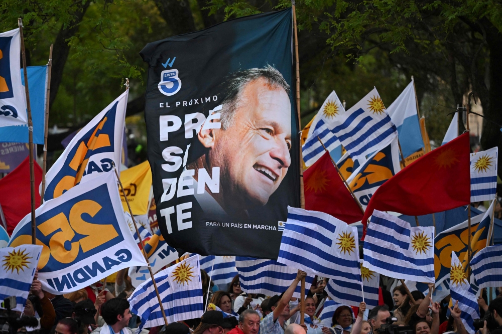 Supporters of Uruguay's presidential candidate for the Republican Coalition, Alvaro Delgado, attend his campaign closing rally in Montevideo on November 20, 2024. Alvaro Delgado of outgoing President Luis Lacalle Pou's ruling coalition and Yamandu Orsi of the left-wing Frente Amplio party will go head-to-head in the November 24 election run-off. — AFP pic