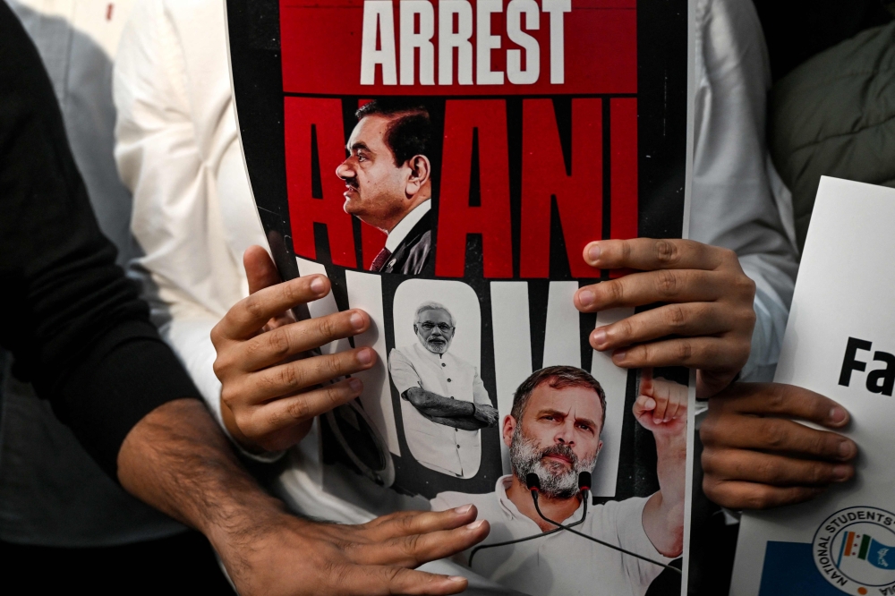 National Students' Union of India (NSUI) activists hold placards as they shout slogans during a protest demanding the arrest of Indian tycoon Gautam Adani over corruption allegations by US prosecutors, in New Delhi on November 21, 2024. — AFP pic